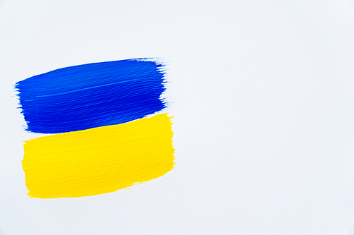 Top view of painted ukrainian flag on white background