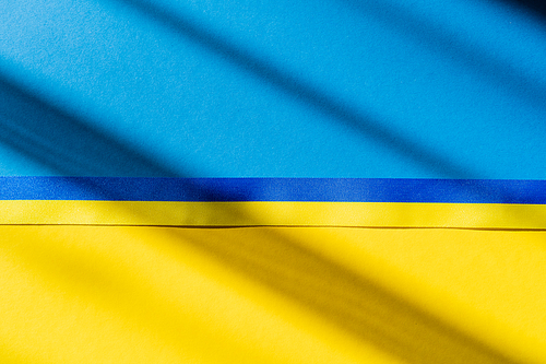 Top view of blue and yellow ribbon on ukrainian flag with shadow