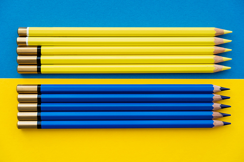 Top view of color pencils on ukrainian flag