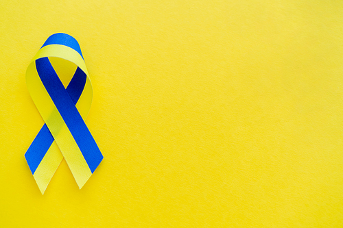 Top view of blue and yellow ribbon on background with copy space