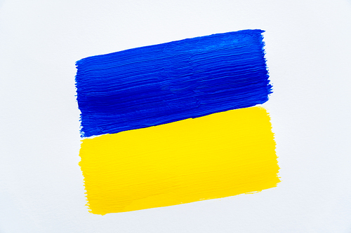 Top view of painted ukrainian flag on white background