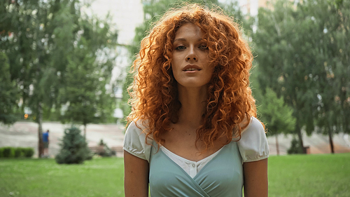 pretty redhead woman  in park