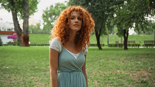 pretty redhead woman  while standing in park