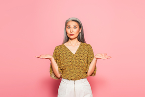 discouraged woman pointing with hands while  on pink