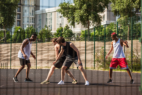 Interracial men training on playground outdoors