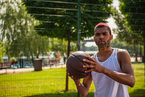 African american sportsman with basketball ball  outdoors