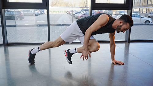 Side view of sportsman training in sports center