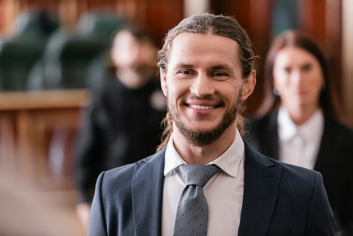happy businessman smiling in court on blurred background