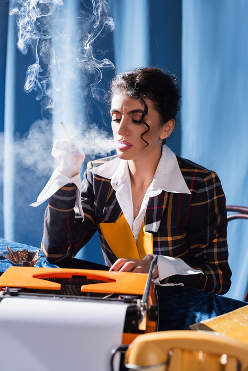 vintage style newswoman typing on typewriter while smoking on blue background