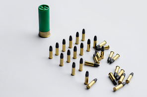 high angle view of bullets and shotgun shell on white background