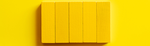 top view of bright rectangular blocks on yellow background, banner