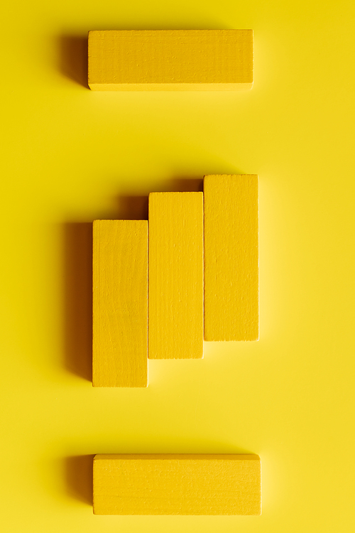 top view of bright tetragonal blocks on yellow background