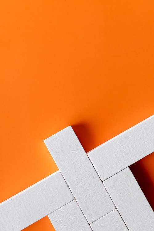 top view of white quadrangular blocks on orange background with copy space