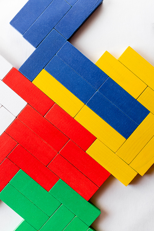 top view of red, yellow and blue rectangular blocks on white background