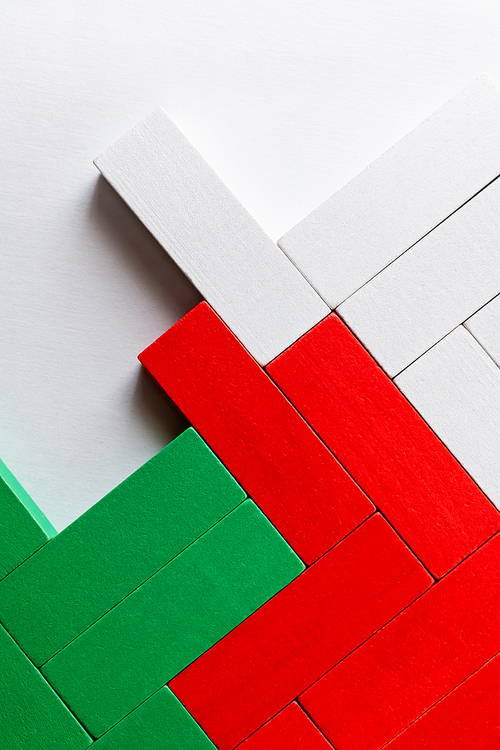 top view of green, white and red blocks on light background