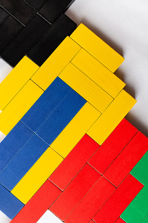 top view of yellow, blue and black rectangular blocks on light background