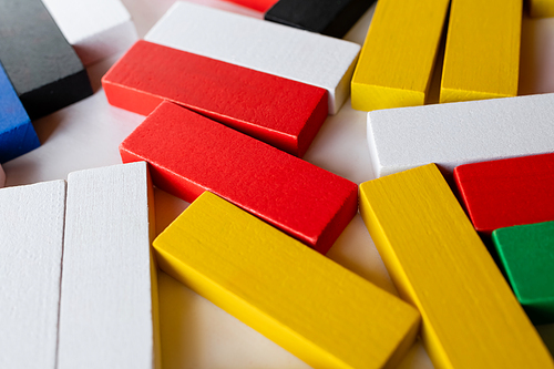 close up view of yellow, white and red blocks on light background