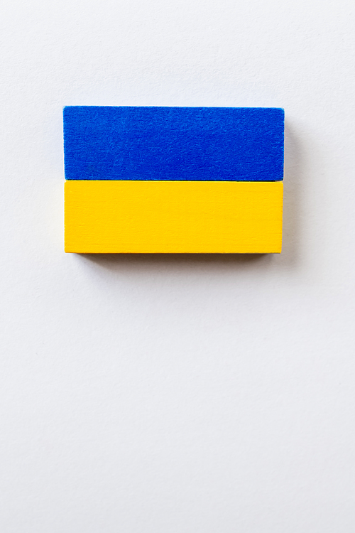 top view of blue and yellow blocks on white background with copy space, ukrainian concept