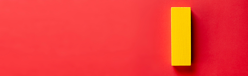 top view of yellow block on red background with copy space, banner