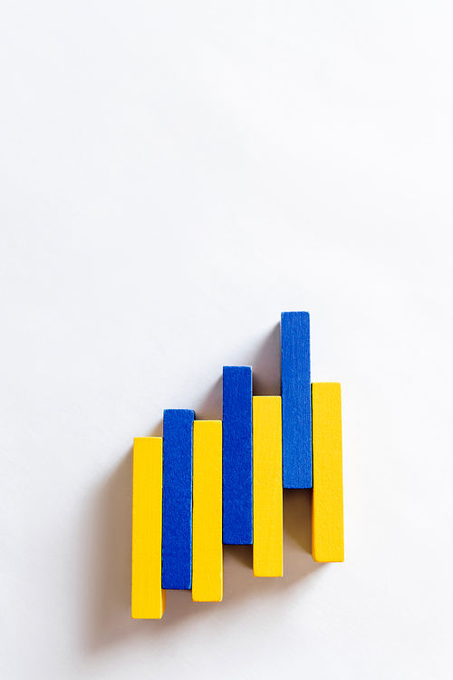 top view of colorful blue and yellow blocks on white background with copy space, ukrainian concept