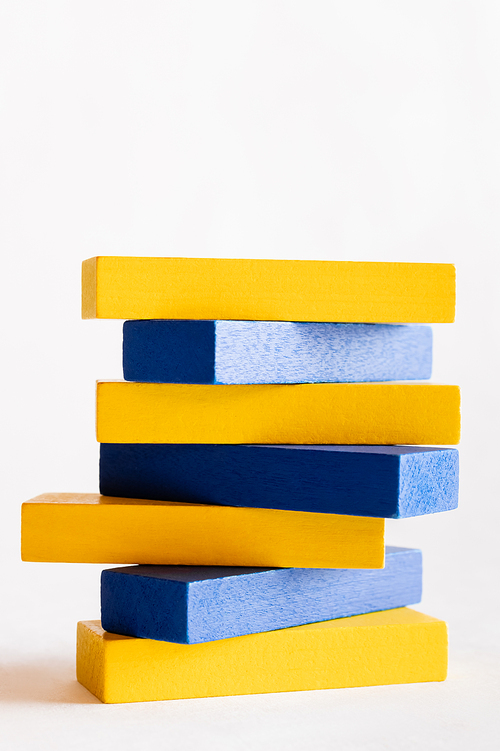 stack of blue and yellow blocks on white background, ukrainian concept