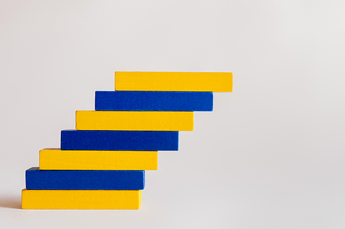 blue and yellow blocks stacked on white background, ukrainian concept