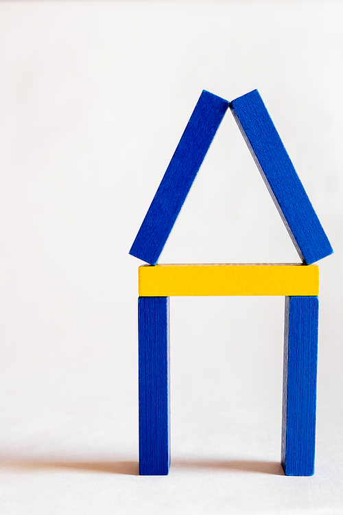 house symbol made of blue and yellow blocks on white background, ukrainian concept