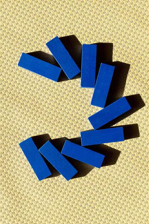 top view of blue tetragonal blocks on beige textured surface