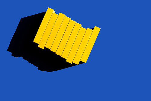 top view of colored yellow blocks on blue background, ukrainian concept