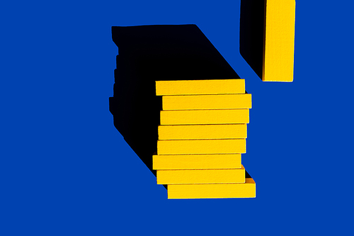 top view of bright yellow blocks on blue background, ukrainian concept