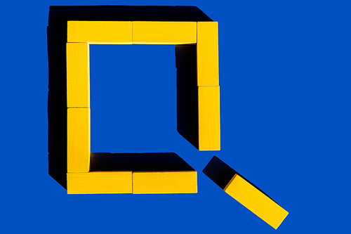 frame of bright yellow blocks on blue background, top view, ukrainian concept