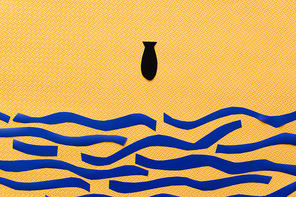 Top view of paper bomb above carton sea on textured yellow background, war in ukraine concept