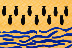 Top view of paper bombs above carton sea on textured yellow background, war in ukraine concept