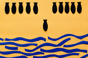 Top view of paper bombs above abstract carton sea on textured yellow background