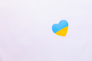 Top view of ukrainian flag in heart shape on white background