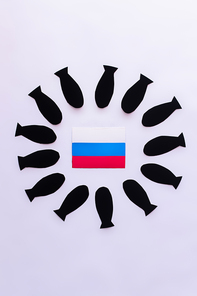Top view of russian flag in frame from paper bombs on white background