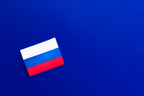 Top view of russian flag on blue background