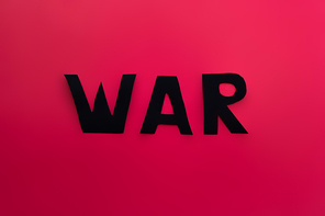 Top view of paper war lettering on red background