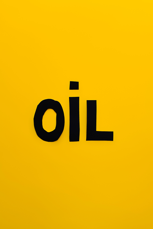 Top view of paper oil word on yellow background