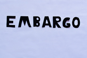 Top view of embargo lettering on white background