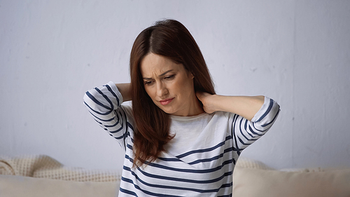 upset woman touching neck while suffering from hurt