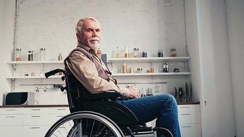 bearded retired man in wheelchair