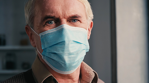close up of senior man in medical mask