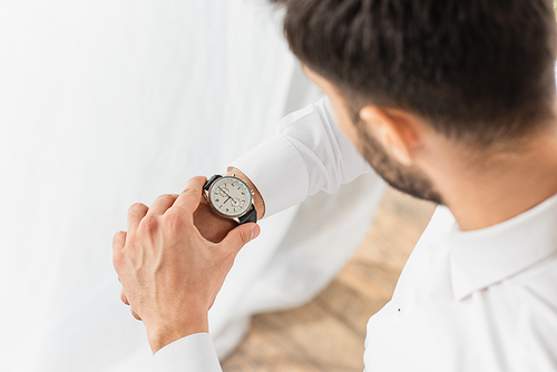 High angle view of blurred businessman wearing wristwatch at home