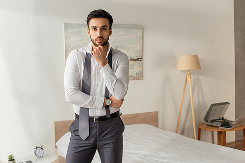 Businessman in shirt and tie  in bedroom