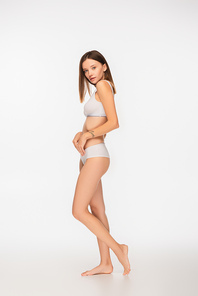 young and slim woman in underwear  on white background