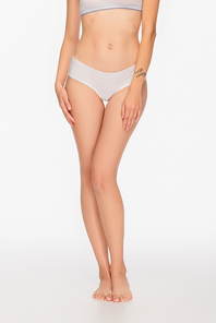 cropped view of barefoot woman with slender legs on white background