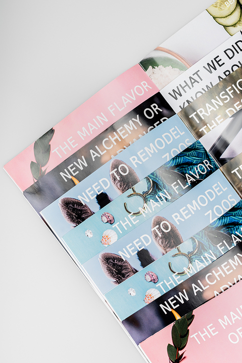 top view of colorful beauty magazines isolated on grey