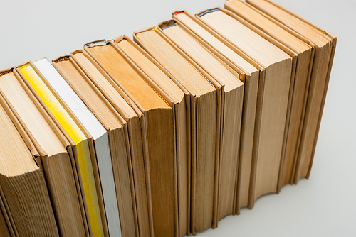 high angle view of row of books on grey background