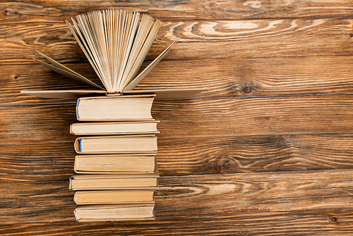 top view of books on textured wooden surface with copy space